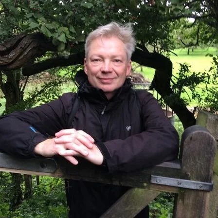 Front facing image of Simon Patterson in a wood