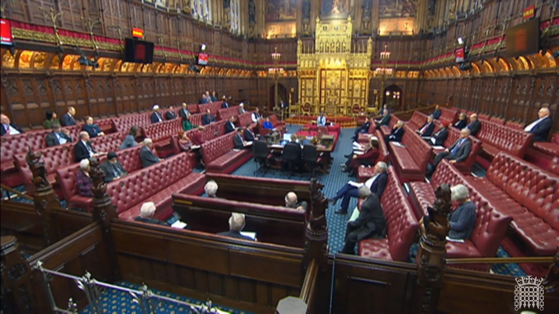 A group of people sitting in an amphitheater where someone in the middle is speaking