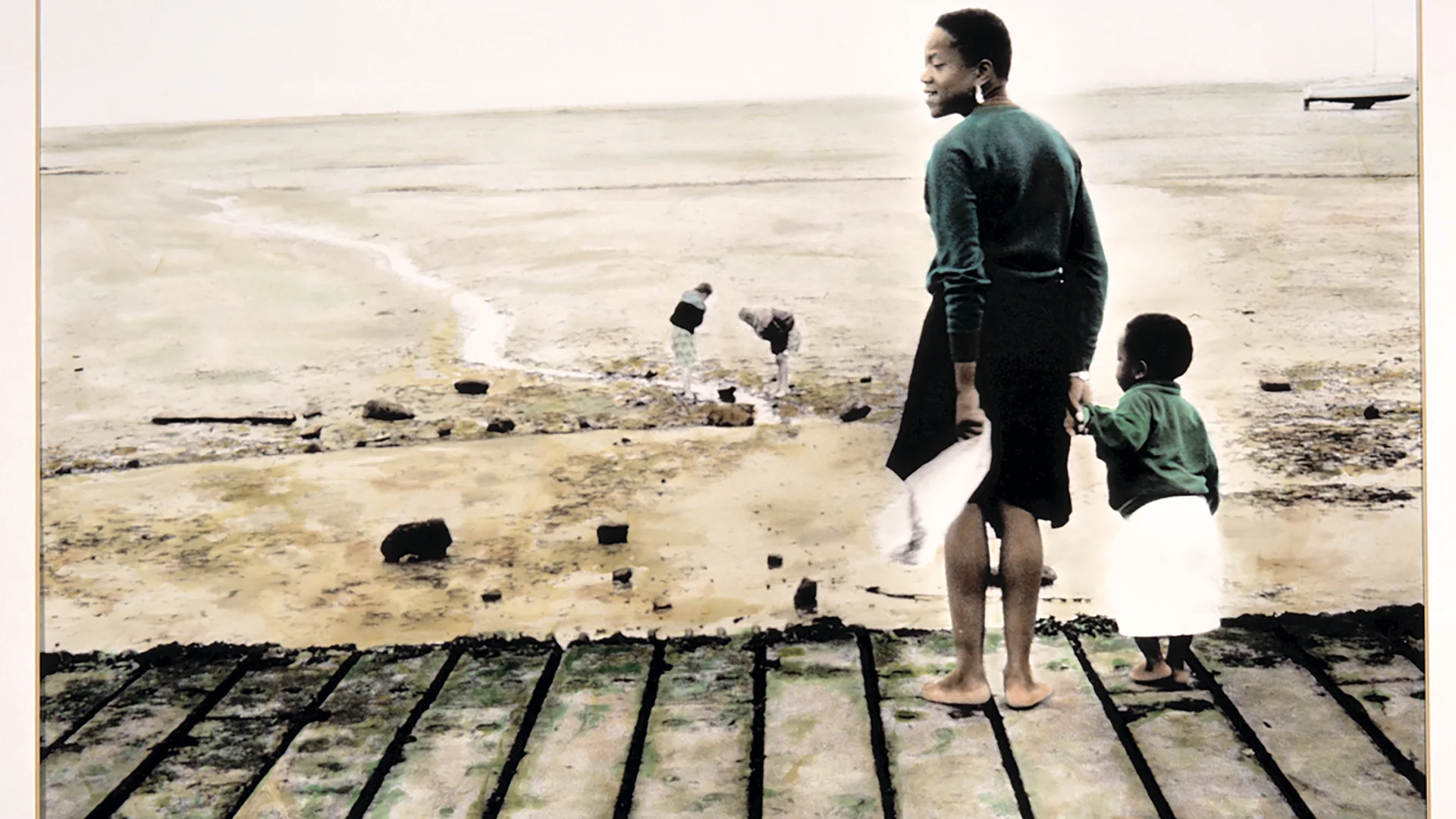 Two people on beach by Ingrid Pollard