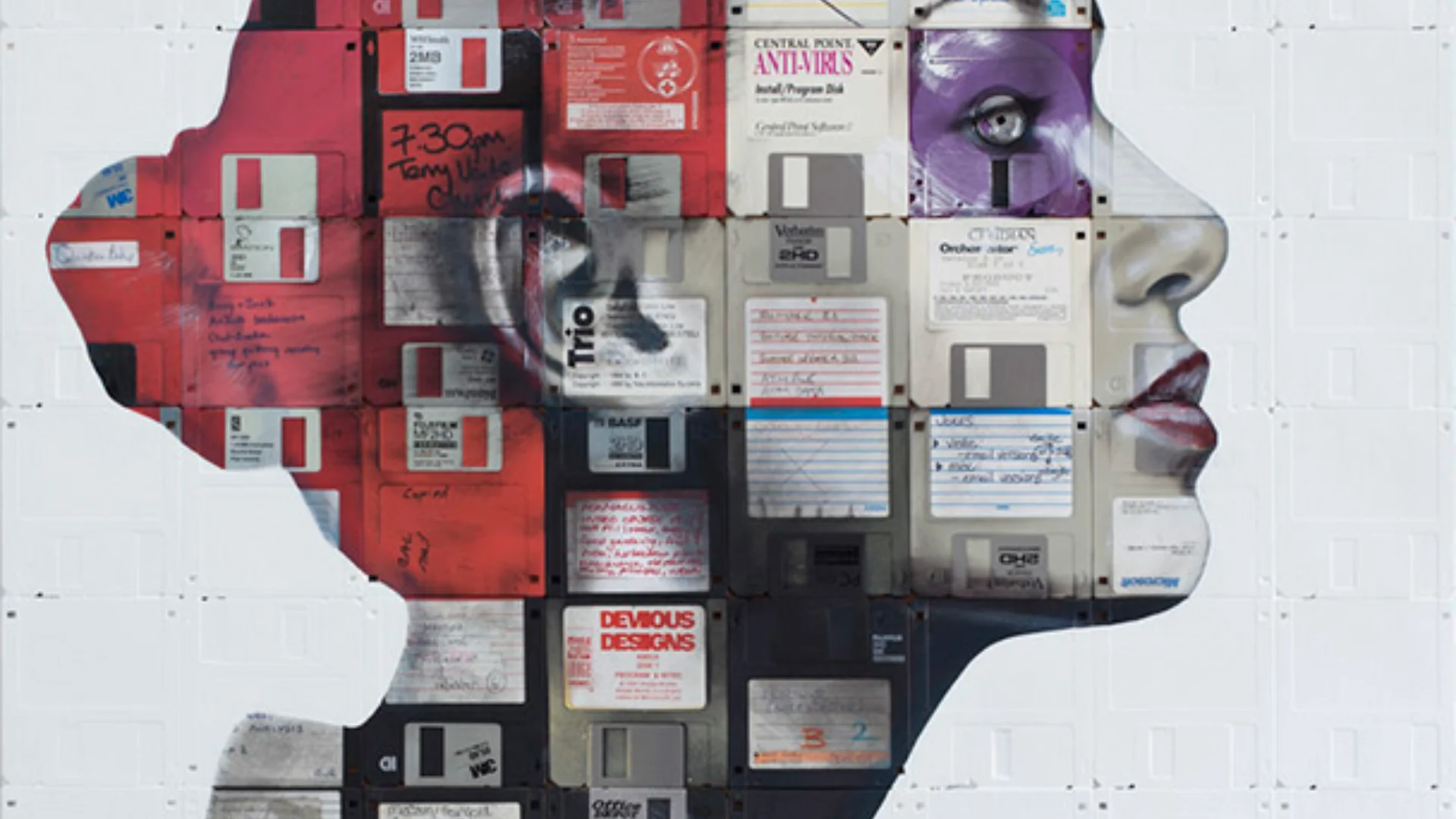 A woman's face, in profile, made up of old floppy disks