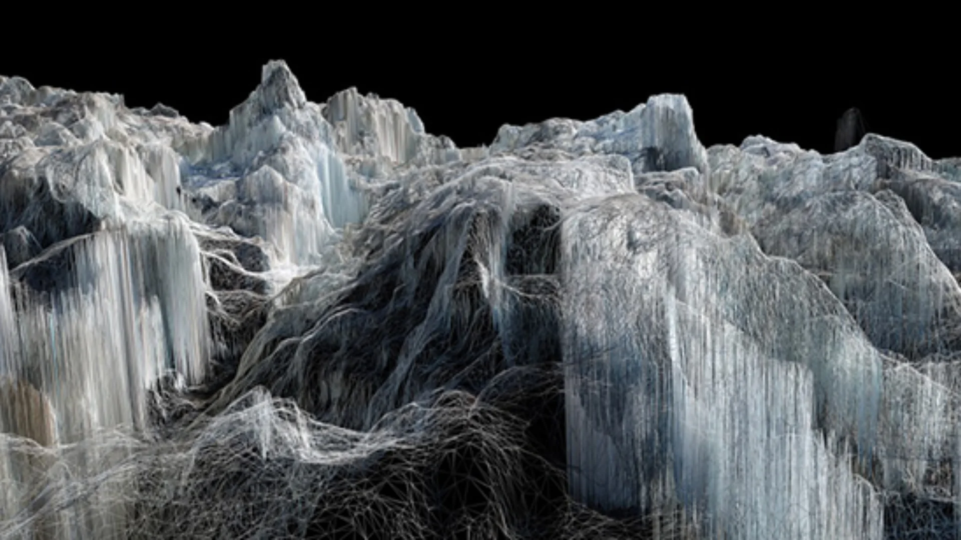 Image of glacier by Dan Holdsworth. The ice fills the frame, is rugged and appears in black and white with edges of blue.