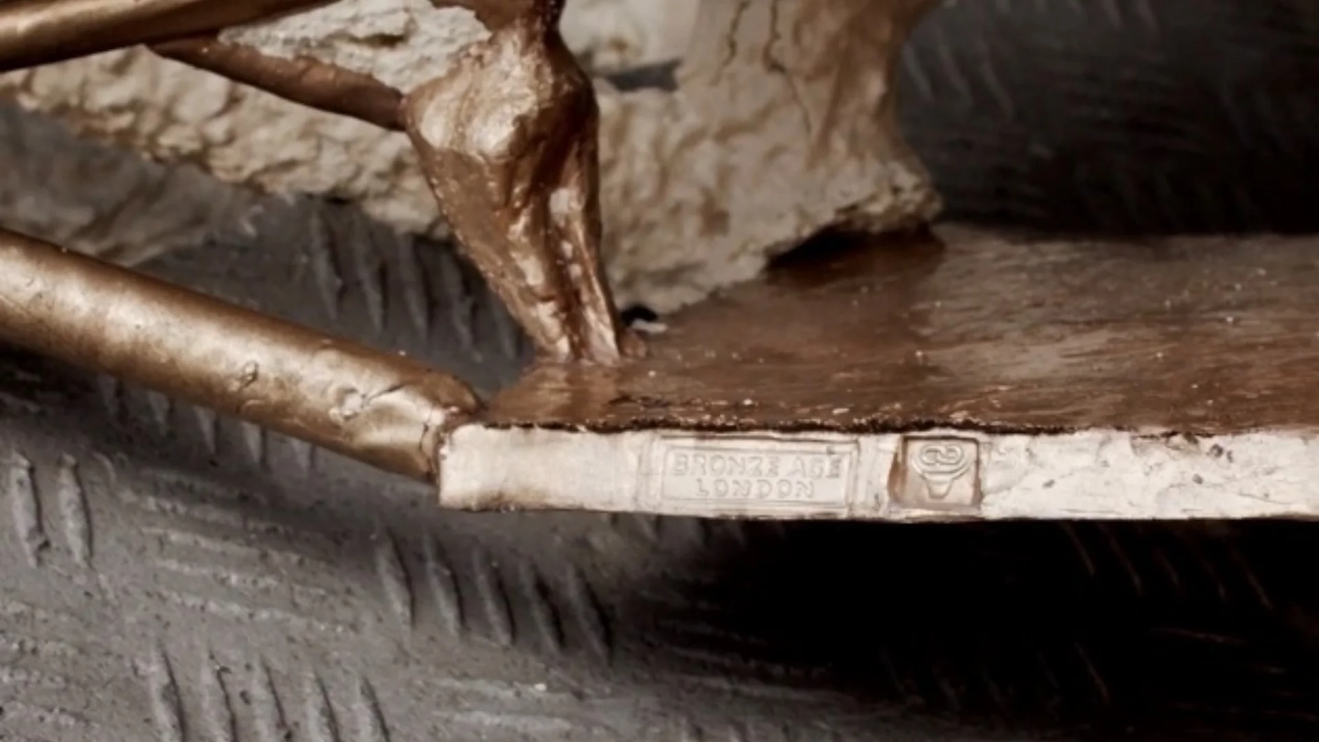 Sculpture featuring the Bronzechain stamp (right) alongside Bronze Age Foundry's stamp.