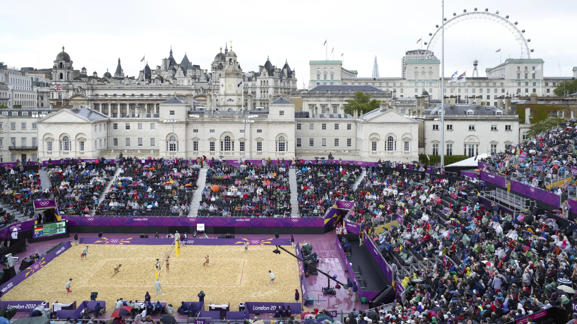 A zoom out of a volleyball match in front of the Horseguards Parade in London