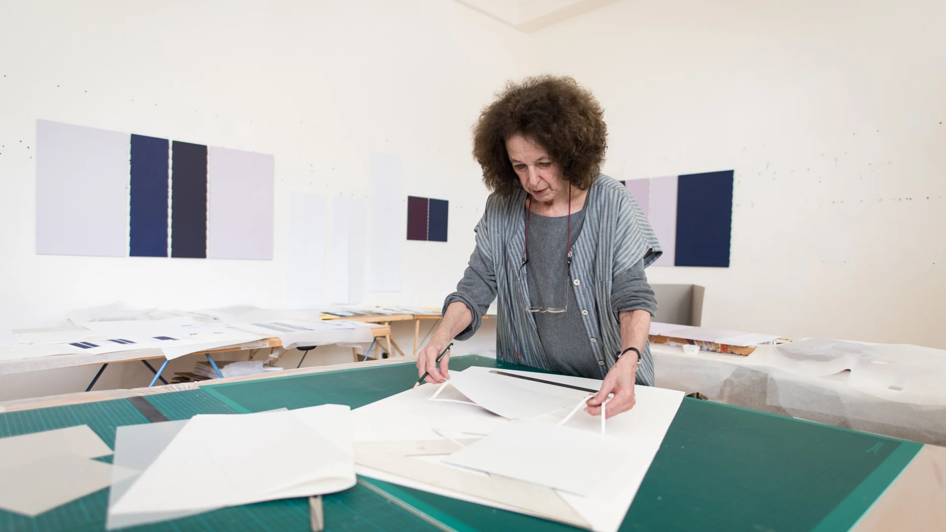 A white woman preparing a drawing on an architecture table