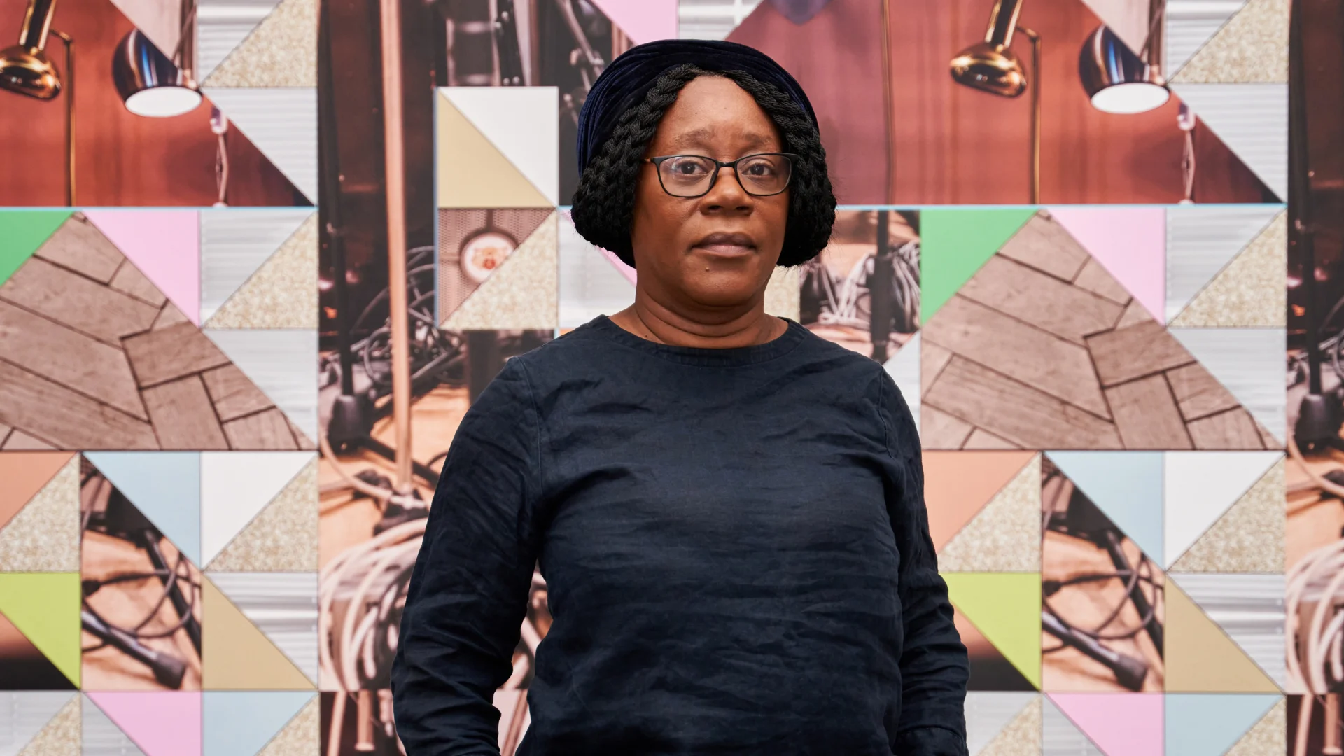 Visual artist Sonia Boyce standing in front of work from her exhibition Feeling Her Way